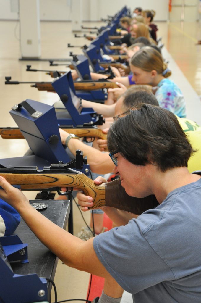 Girl Scout troop taking shots down range.