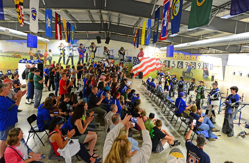 Photo of the crowded firing line and audience during the Final.