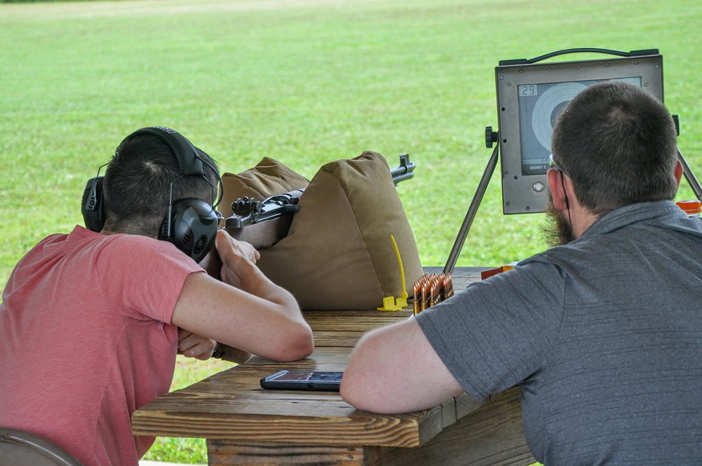 Competitor firing off a bench at a target.