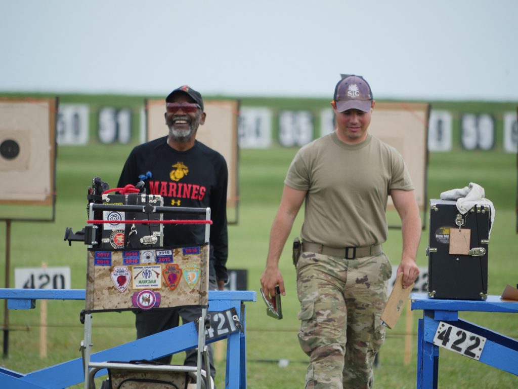 Competitors smiling returning to firing line
