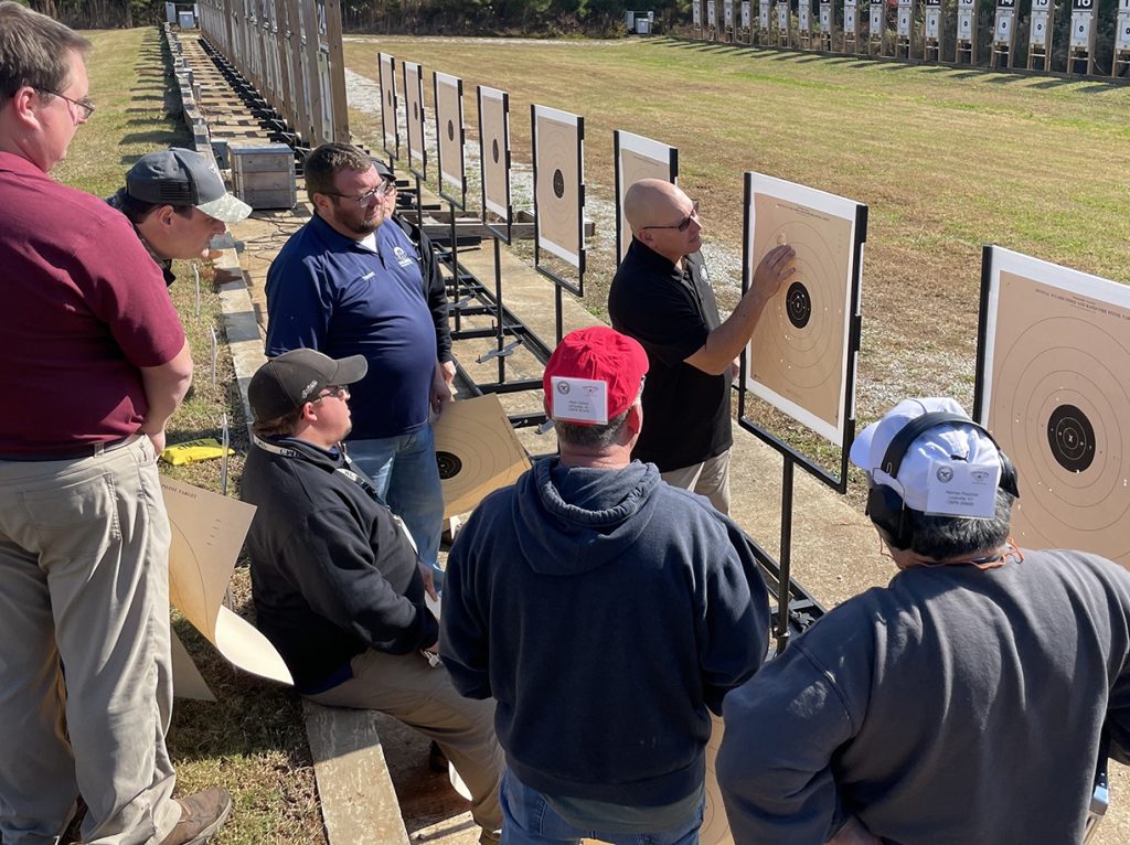 Firearms instructor showing shots on target