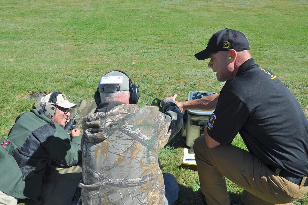 USAMU Rifle Instructor assisting on the firing ling during the Rifle Marksmanship 101 course.