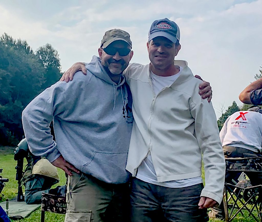 Two friends posing on firing line.