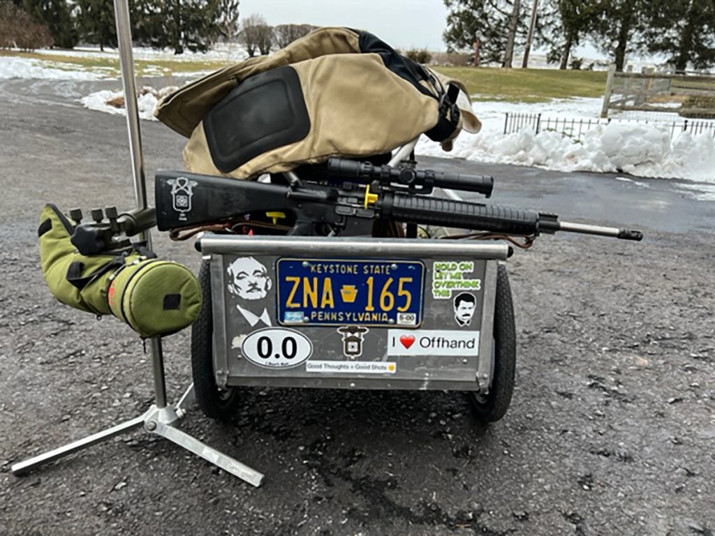 Photo of rifle, shooting cart and scope.