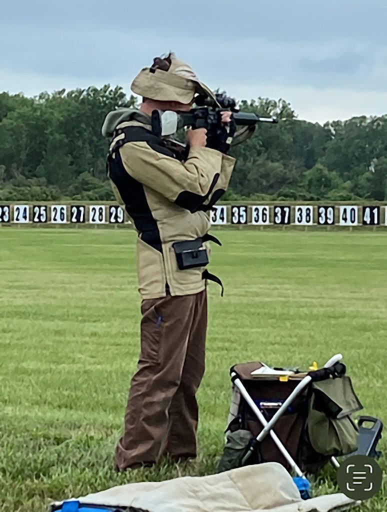 Adam firing in the standing position with rifle.