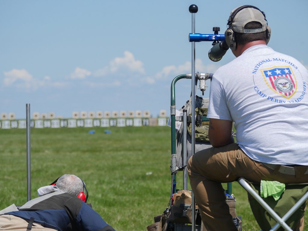 Rifle shooter firing down range.