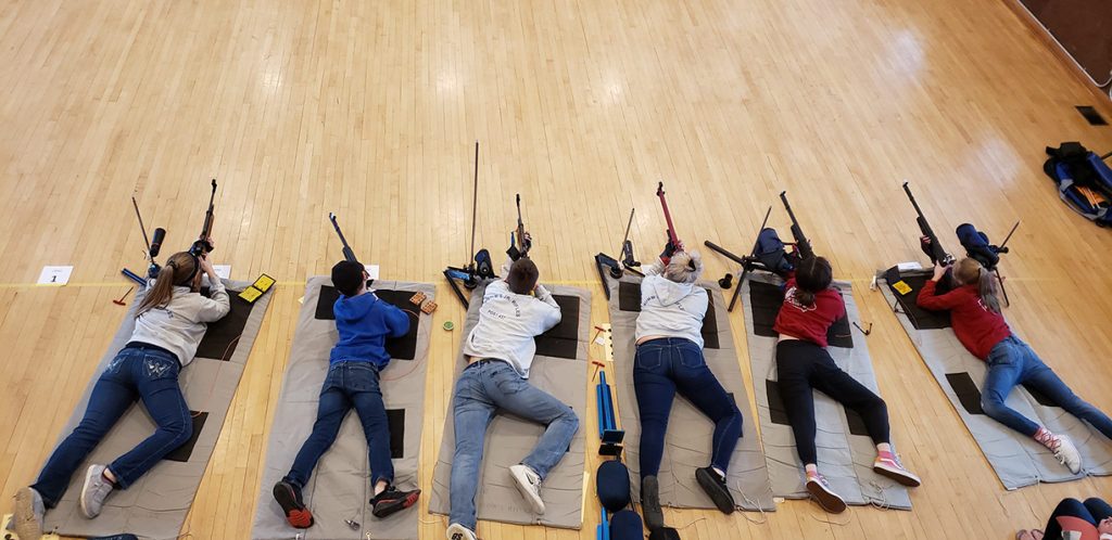 Juniors in prone position shooting downrange