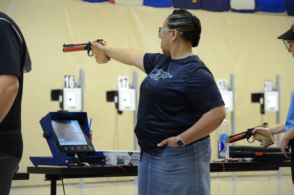 Renay firing pistol