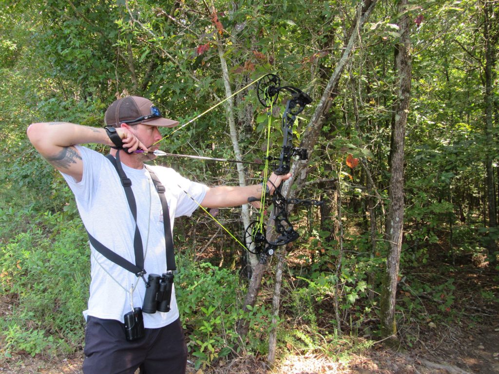 Archery competitor aiming at target