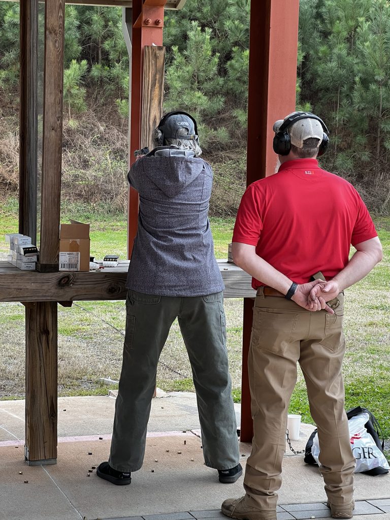Guest firing a pistol at target