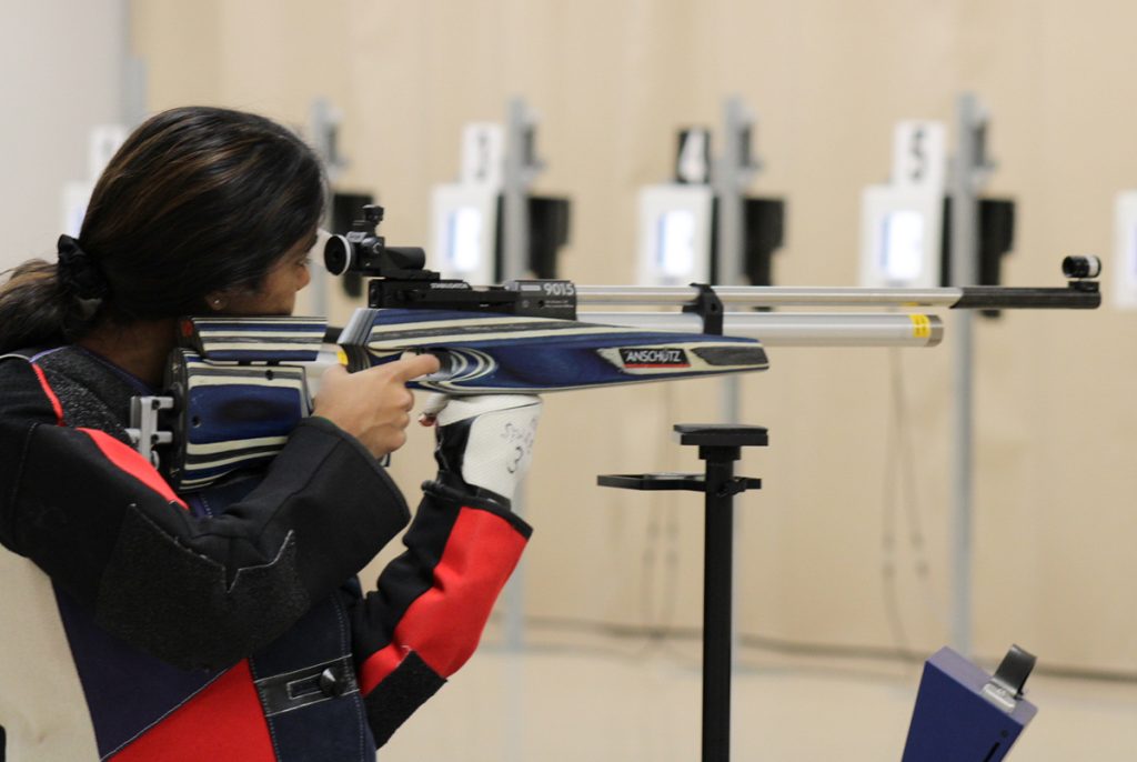 Precision rifle competitor aiming downrange