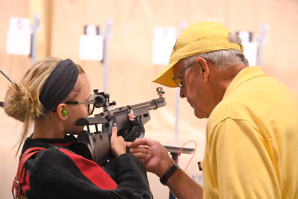 Rifle junior with coach on firing line