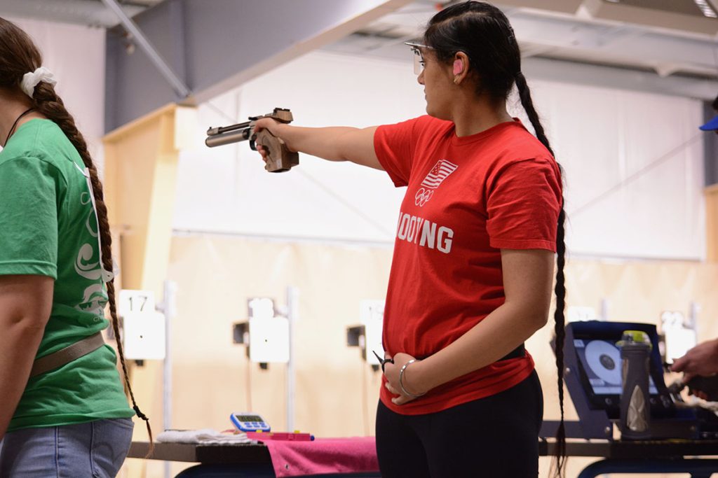 Suman aiming pistol downrange