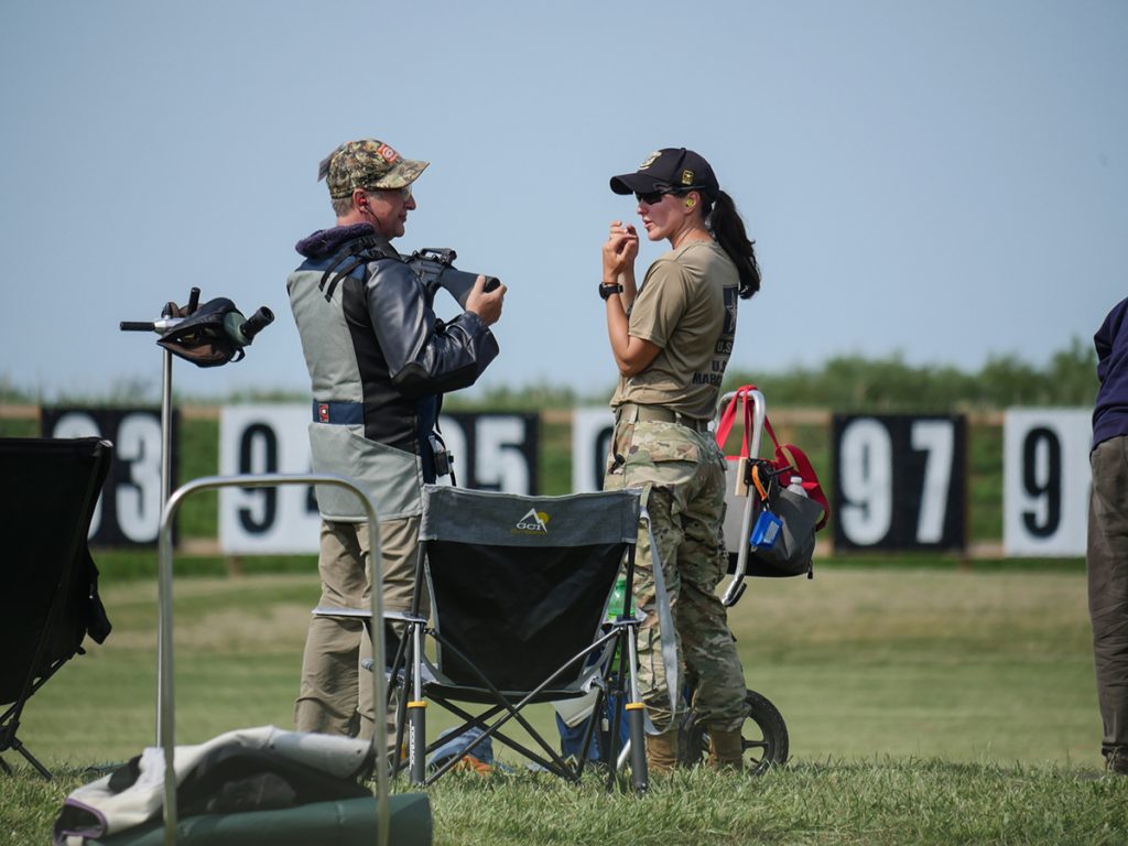 Coach with rifle competitor on the firing line