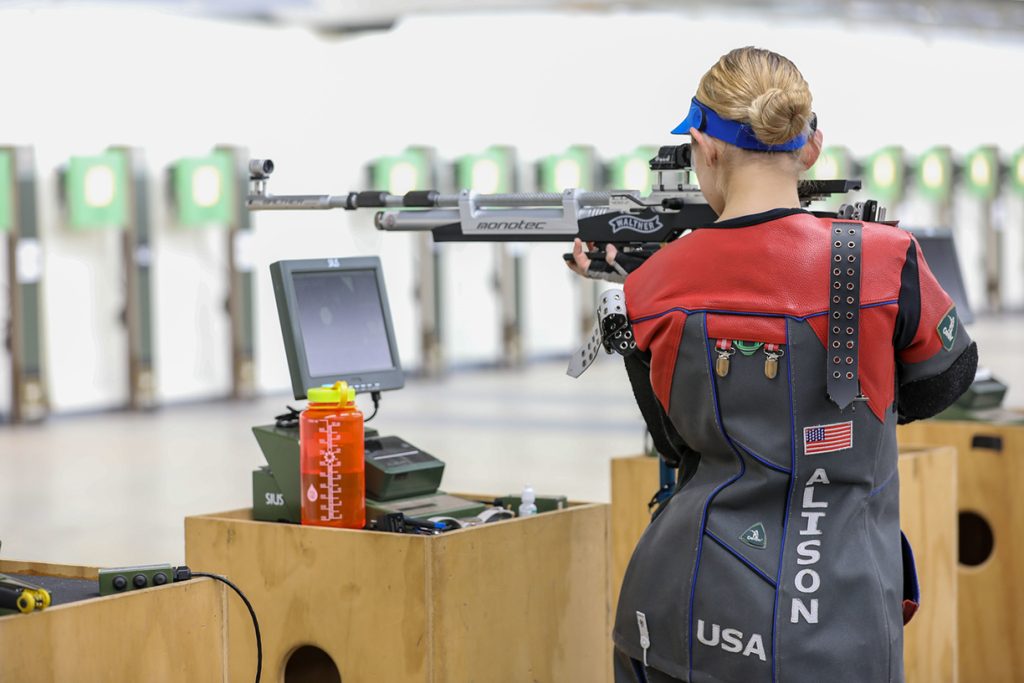 Ali aiming rifle downrange