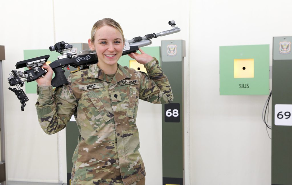 Ali Weisz poses for a photo with air rifle