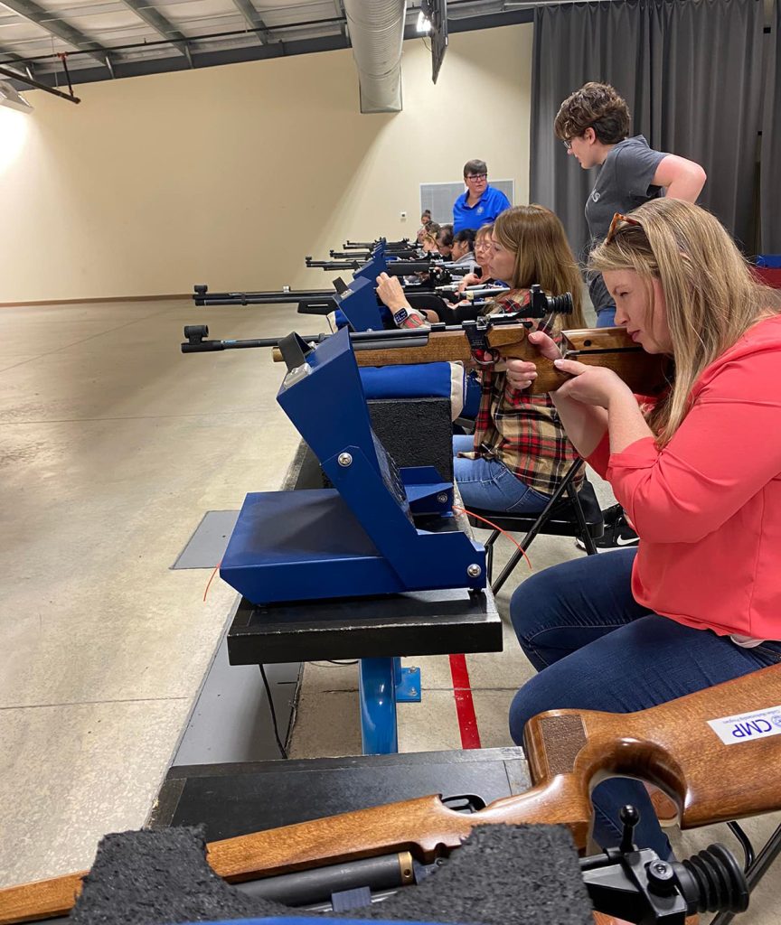 Group of ladies shooting downrange.