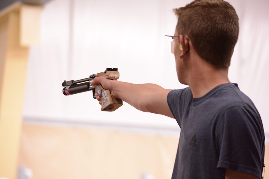 Johnathan aiming his pistol downrange.