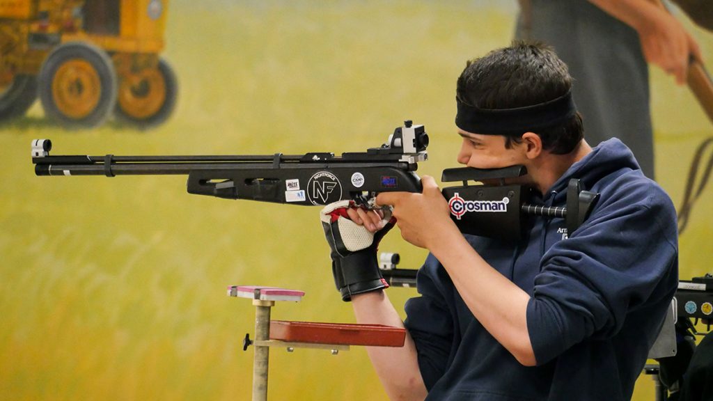 Junior sporter air rifle competitor firing down range.