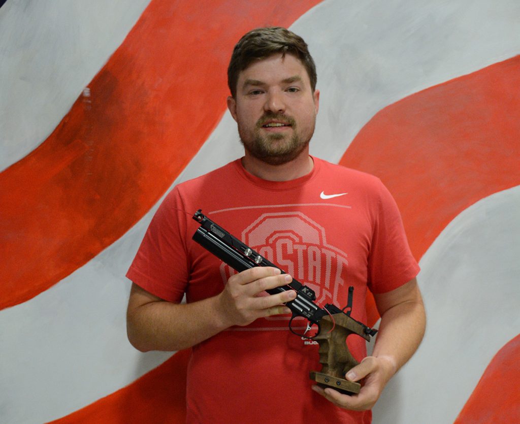 Anthony Lutz pose with his air pistol