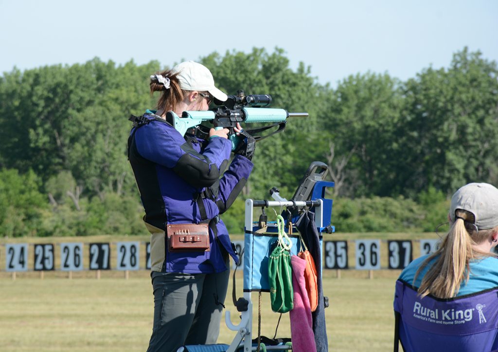 Junior in the standing position firing a shot downrange