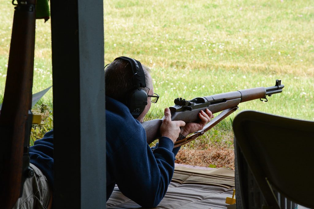 Rifle competitor firing an M1 Garand in the Prone position