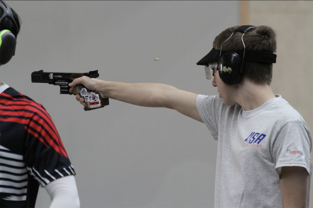Henry fires a shot downrange as a member of the Ohio State Pistol Team.