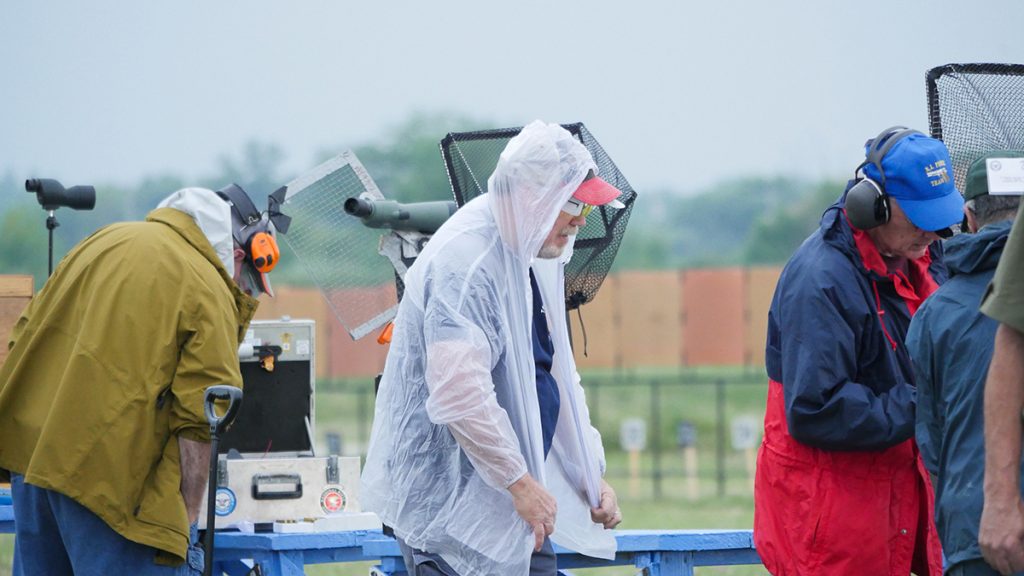 Competitors put on rain gear preparing for the rain.