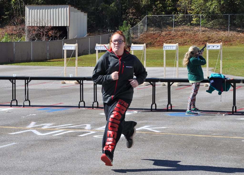 Girl running outside during the target sprint event.