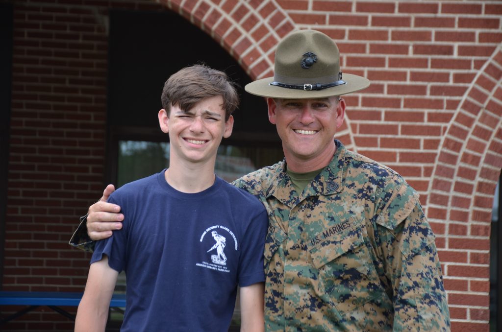 Nick Capko stands outside with his arm around his teenage son, Caleb.