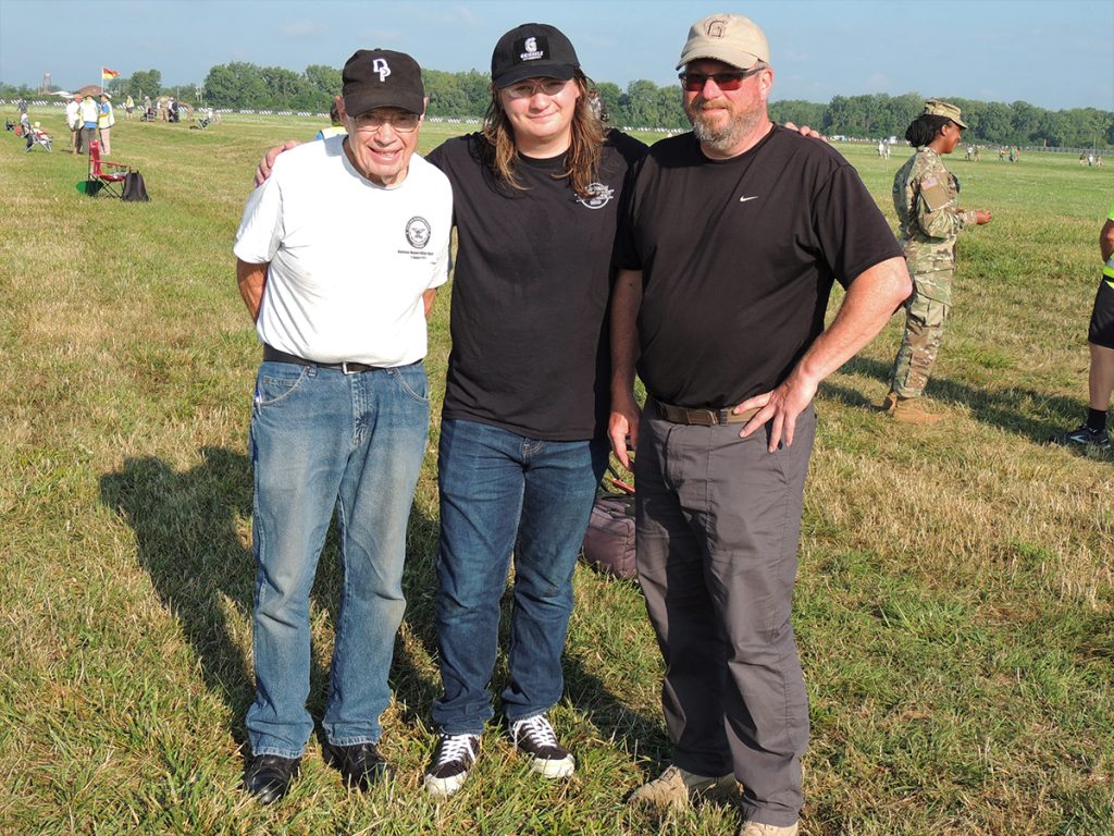 Gerald, Cole, and David Williams standing together outside at the 2022 National Matches.