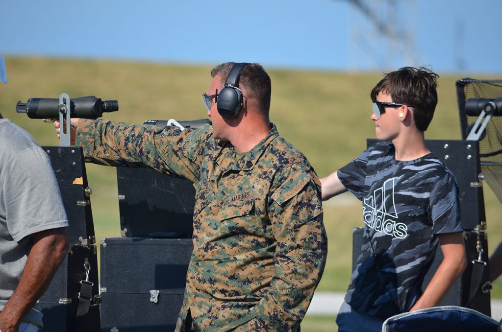 Nick and Caleb competing side by side in a pistol match.