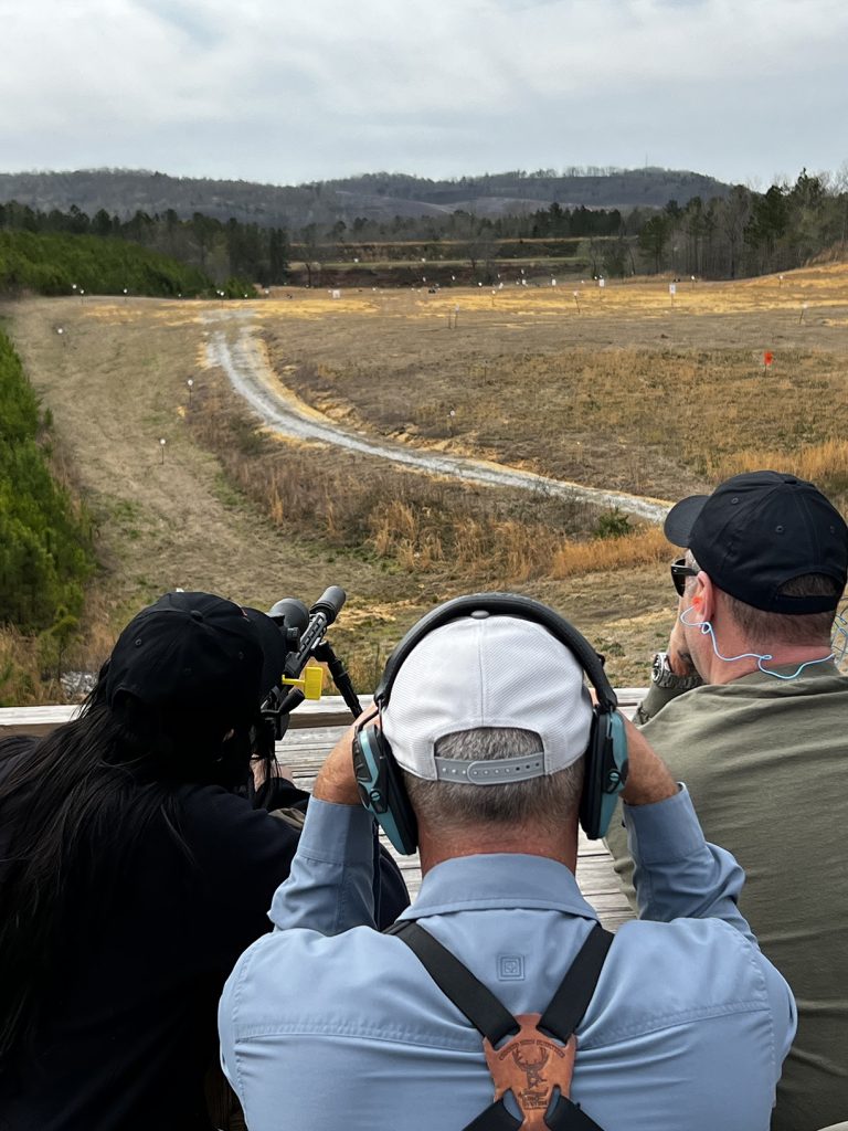 A group of three people shooting on the Unknown Distance range.