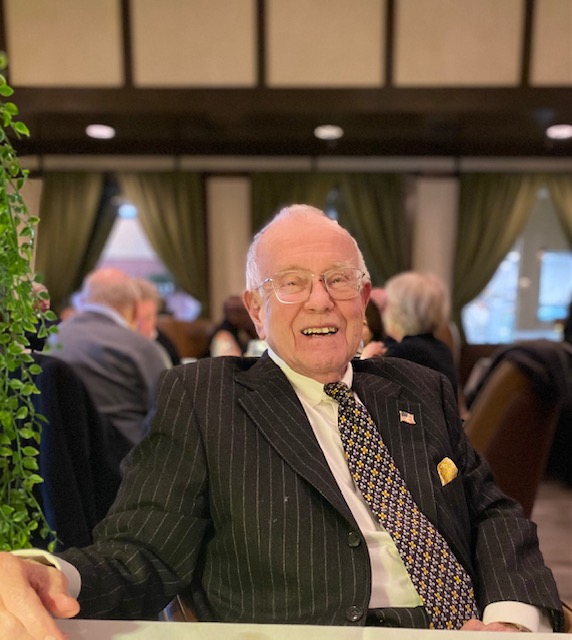 Harry Gaunt, seated at a table and smiling for the camera.