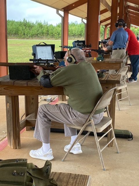 Harry firing a rifle at the CMP Talladega Marksmanship Park.