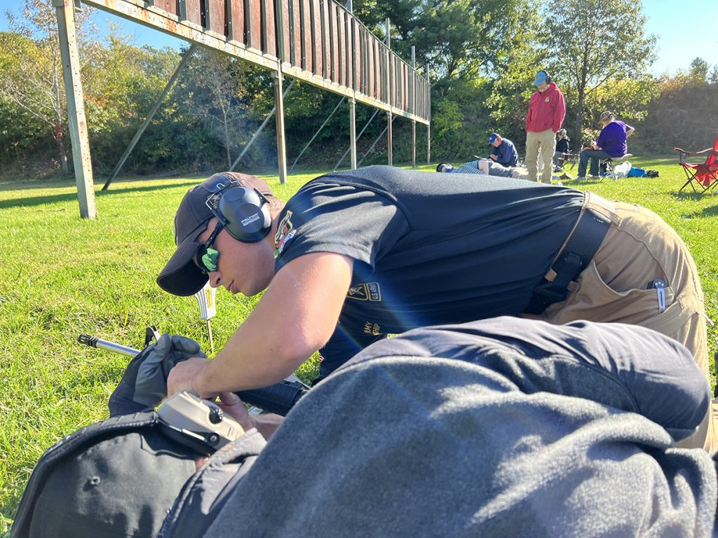 USAMU Rifle Team member provides hands on instruction to student in the class.