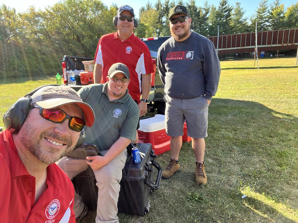 CMP Staff members smile for a photo at the range.