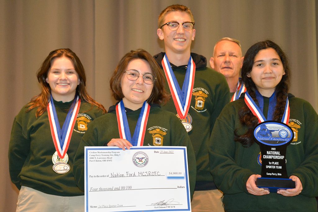 Nation Ford High School MCJROTC Rifle Team on the podium.