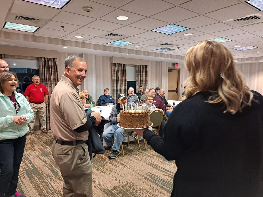 Jerry O'Keefe being presented with a birthday cake.