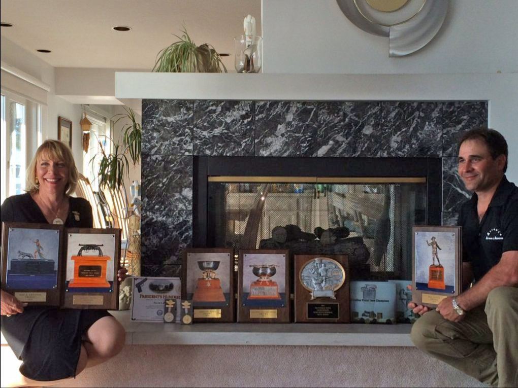 David and Kathy posing with their award plaques.