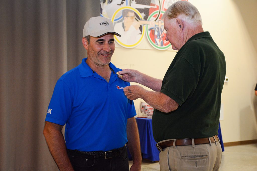 Lange receives his Distinguished Badge from Mr. Gary Anderson, DCME.