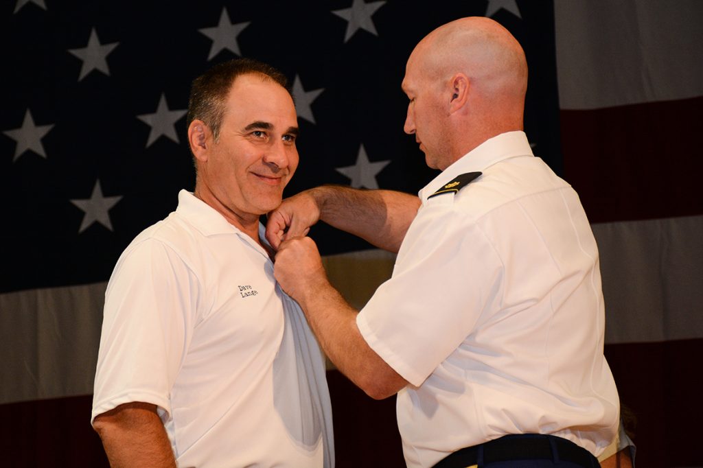 David receives the CMP Distinguished Revolver Badge on stage during the Awards Ceremony.