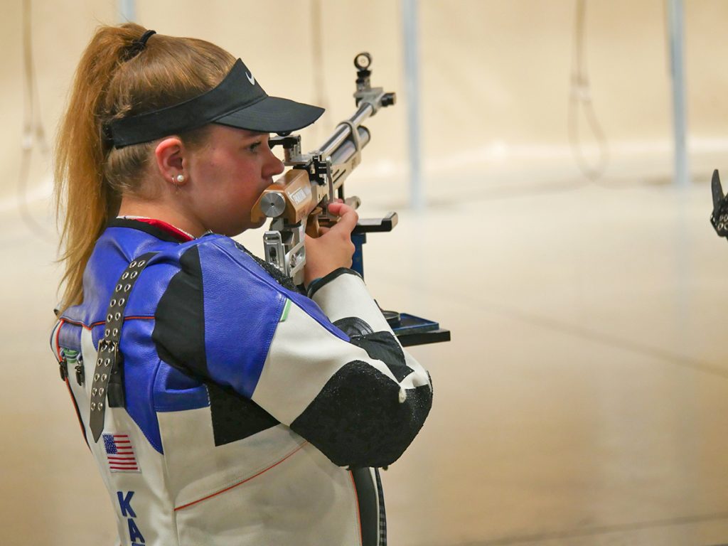 Katrina Demerle on the firing line, with her air rifle resting on the stand.