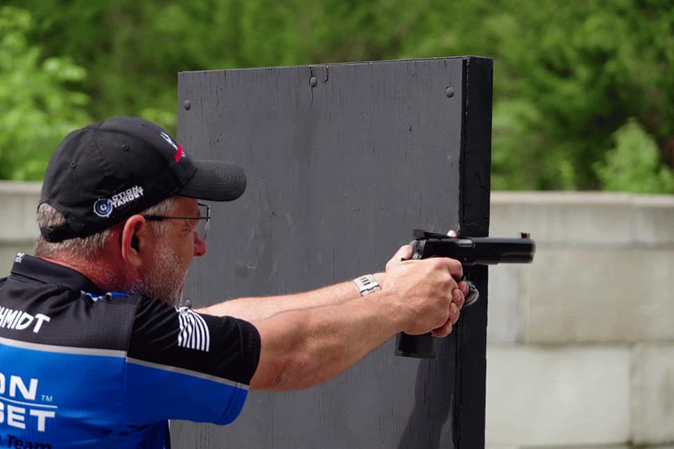 Action pistol competitor taking a shot.
