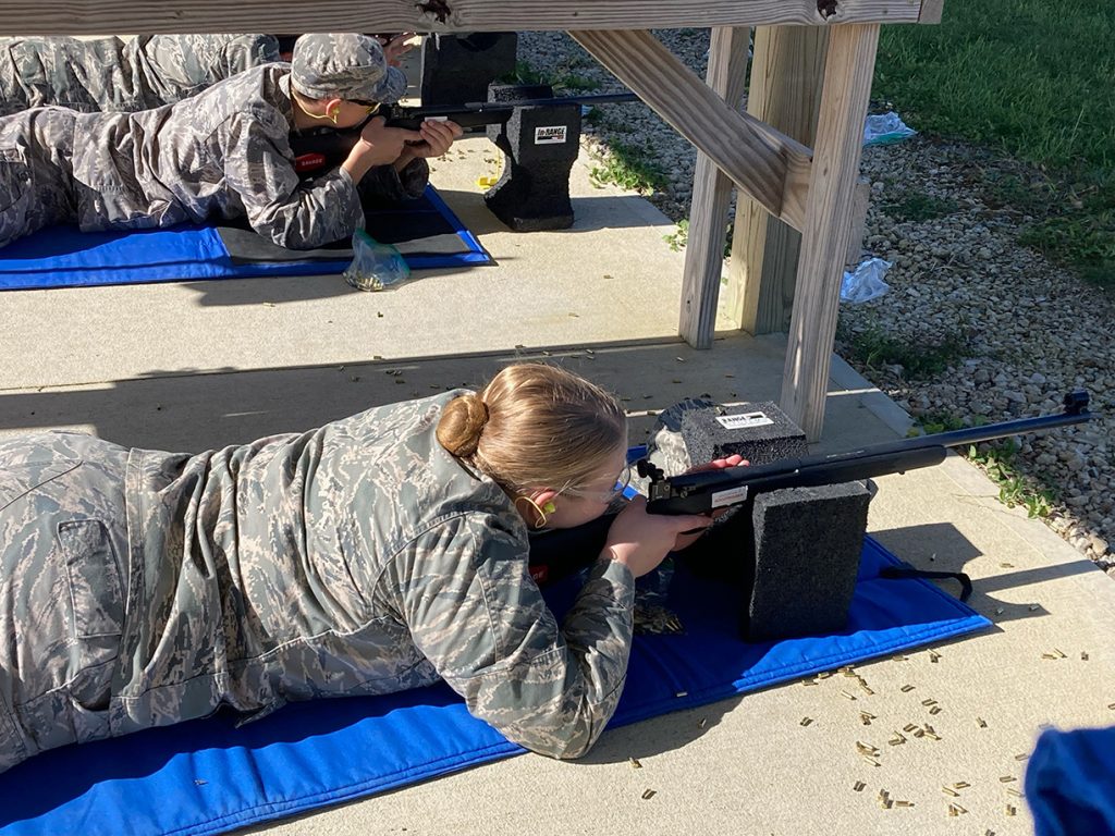 Cadets firing .22 caliber rifles in the prone position.