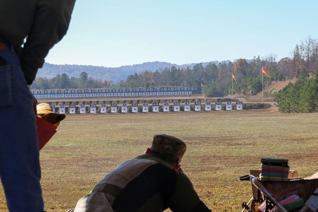 Rifle competitor aiming at targets at the CMP Talladega Marksmanship Park.