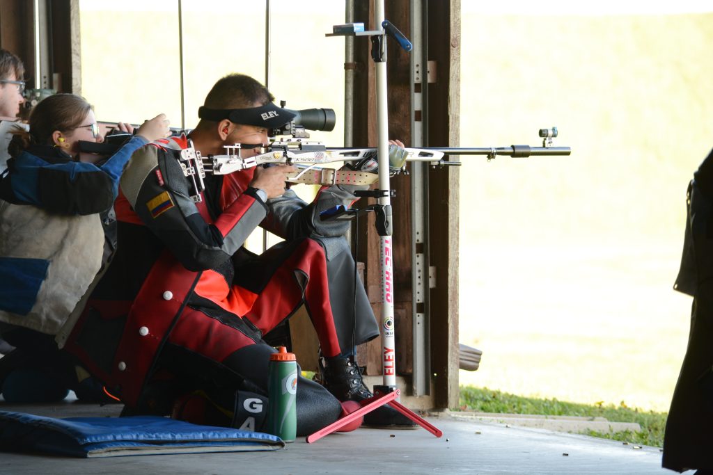 Smallbore competitor in the kneeling position firing at target