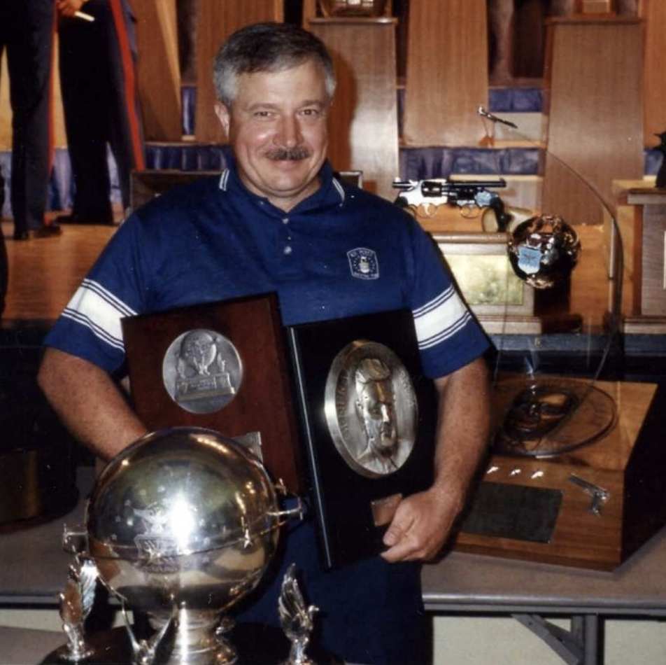 Robert Engelmeier, wearing a blue polo shirt, posed with the LeMay trophy.