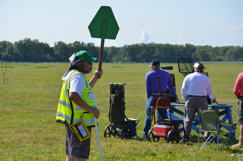 Man with paddle in open field