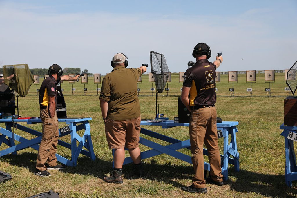 Competitors with pistols on a range